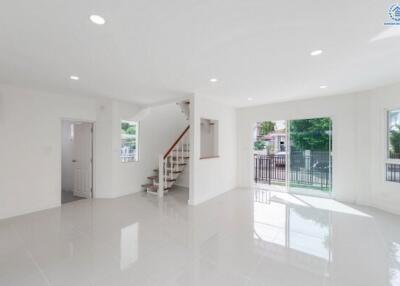 Spacious and bright living area with stairs and sliding glass doors