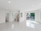 Spacious and bright living area with stairs and sliding glass doors