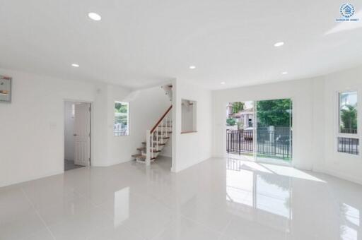 Spacious and bright living area with stairs and sliding glass doors