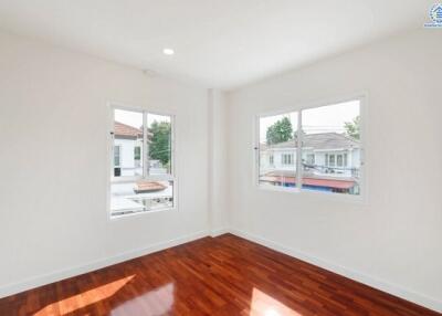 bright and spacious bedroom with wooden floor