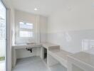 Minimalist kitchen with white walls and a window