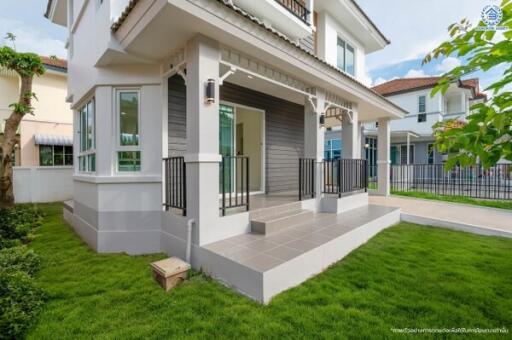 Modern two-story house exterior with front porch and lawn