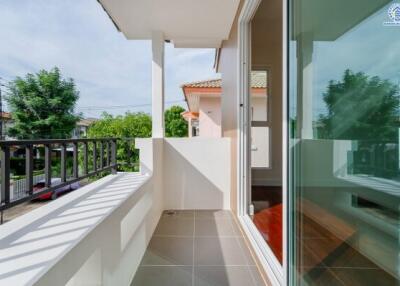 Small balcony with glass door and outdoor views