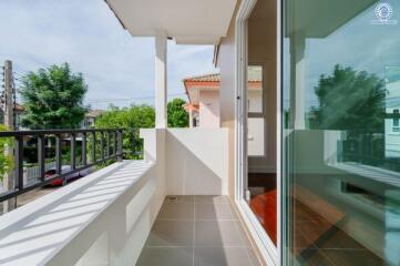 Small balcony with glass door and outdoor views