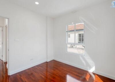 Bright bedroom with wooden floor and window