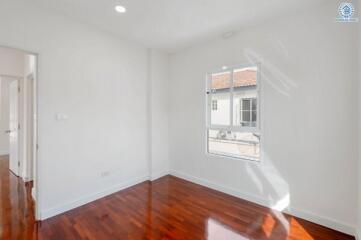 Bright bedroom with wooden floor and window