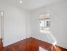 Bright bedroom with wooden floor and window