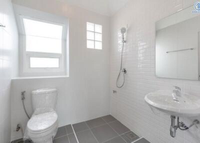 Modern bathroom with white walls and fixtures