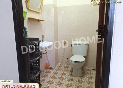 Bathroom with sink, toilet, and storage shelves