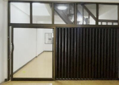 Bright empty interior with tiled floor and glass partition in building