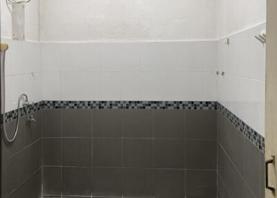 Bathroom with tiled walls and a toilet