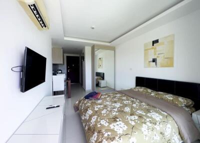 Modern bedroom with TV and floral duvet