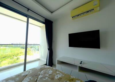 Bedroom with large window and balcony access