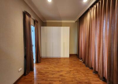 Spacious bedroom with wardrobe and wooden flooring