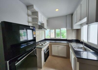 Modern kitchen with black appliances and white cabinetry