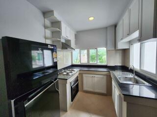 Modern kitchen with black appliances and white cabinetry