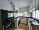 Modern kitchen with black appliances and white cabinetry