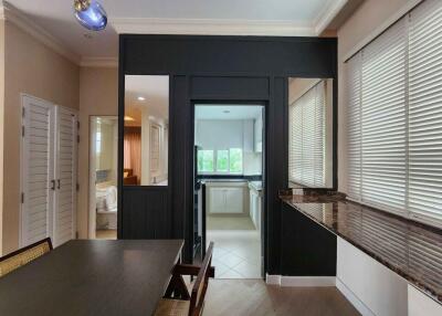 Dining area with view into kitchen and bathroom