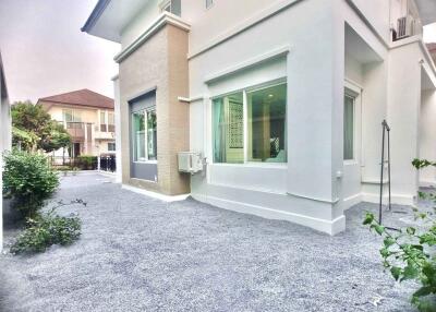 Front view of a modern two-story house with a small yard