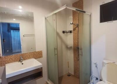 Modern bathroom with glass shower enclosure and sleek fittings