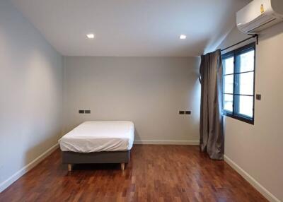 Spacious bedroom with wooden floors