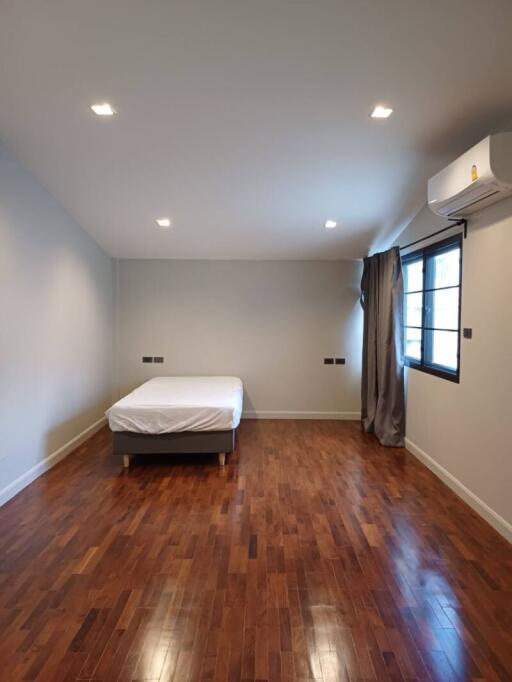 Spacious bedroom with wooden floors