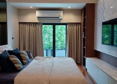 spacious bedroom with wooden ceiling and modern decor