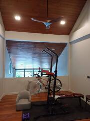 Home gym with exercise equipment and wooden ceiling