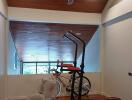 Home gym with exercise equipment and wooden ceiling