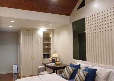 Modern bedroom with wooden ceiling and decorative pillows