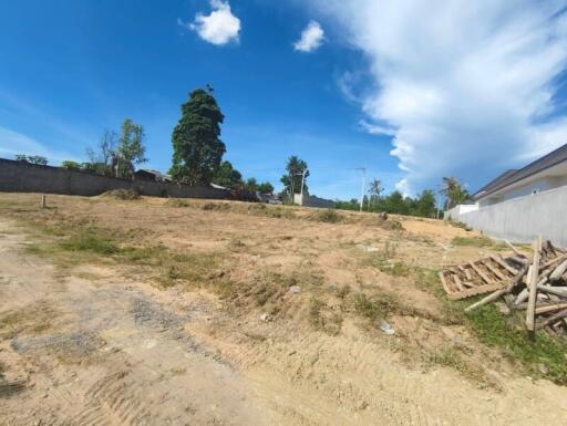 Vacant plot of land with clear blue sky