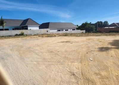 Empty plot of land with neighboring houses