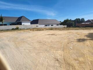 Empty plot of land with neighboring houses