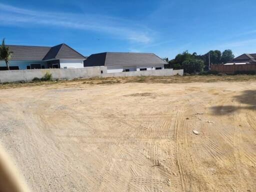 Empty plot of land with neighboring houses