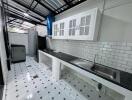 Modern kitchen with white cabinets and tiled backsplash