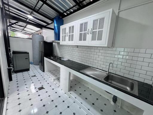 Modern kitchen with white cabinets and tiled backsplash