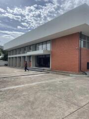 Two-story commercial building front view with parking area