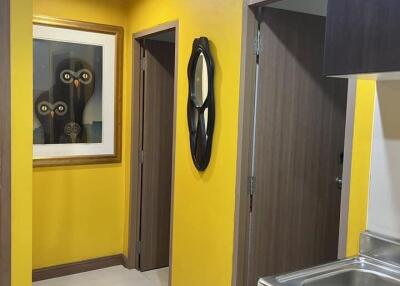 Hallway with yellow walls and modern decor