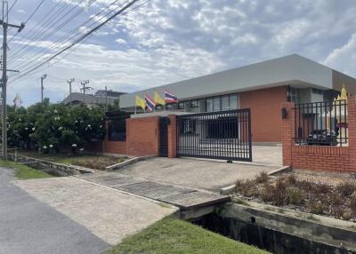 Modern single-story building with flags