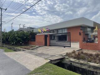 Modern single-story building with flags