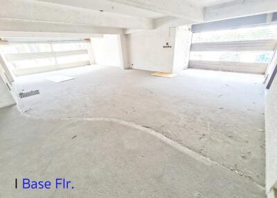 Open basement floor with concrete flooring and large garage doors