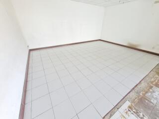 Spacious empty room with tiled flooring