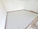 Spacious empty room with tiled flooring