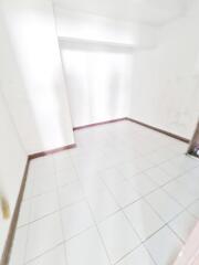 Empty tiled room with white walls