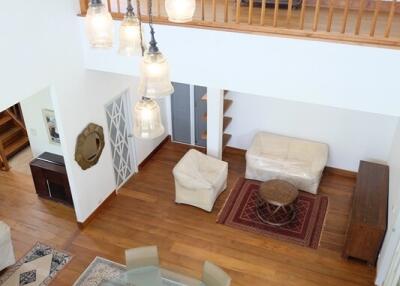 Main living space with view from above, featuring dining and seating areas