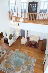 Main living space with view from above, featuring dining and seating areas