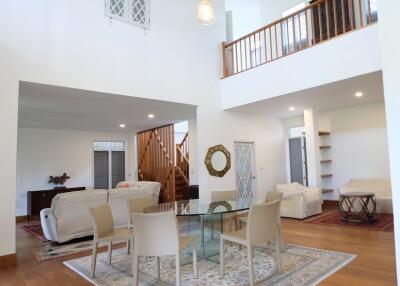 Spacious two-story living room with modern furniture and high ceiling