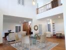 Spacious two-story living room with modern furniture and high ceiling