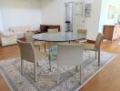 Dining room with glass table and beige chairs