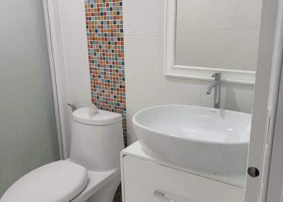 Modern white bathroom with colorful mosaic tiles